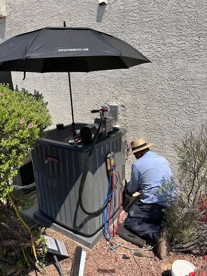 HVAC technician performing outdoor AC maintenance in Maitland